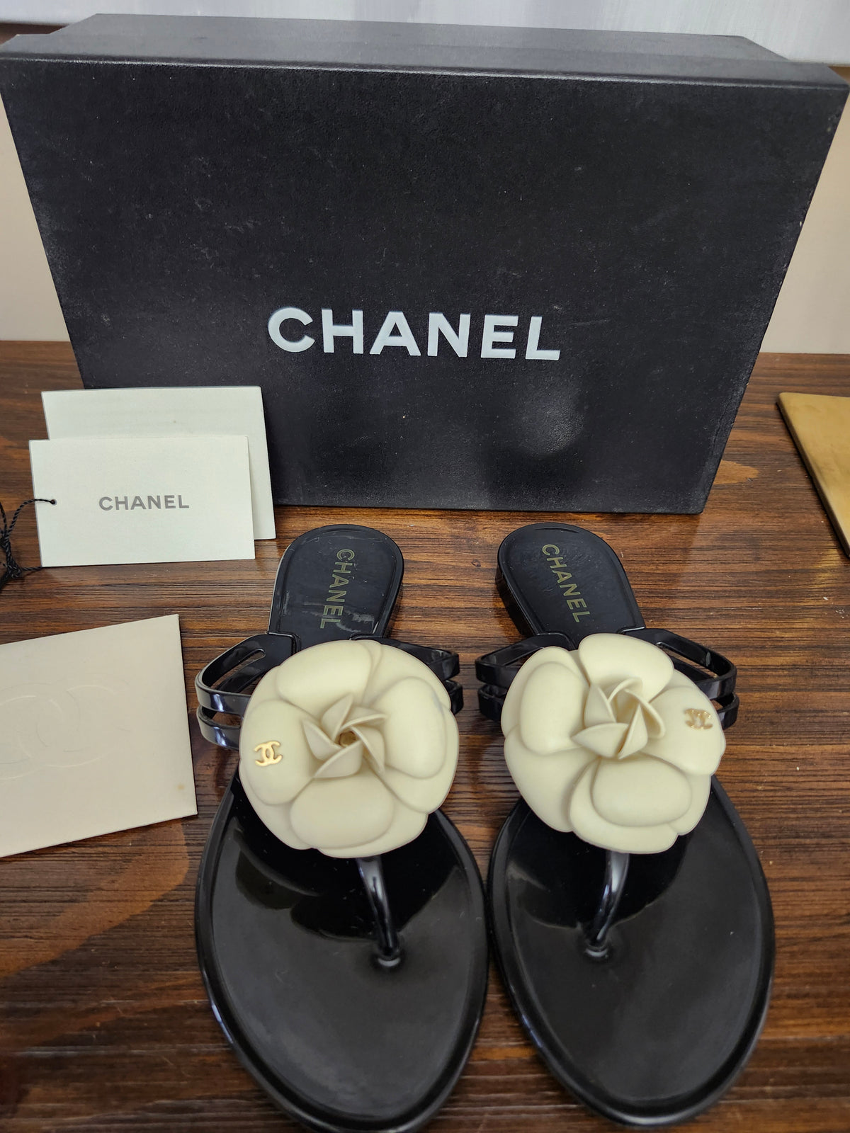 Chanel Black Jelly Camellia Sandals in Size 36 featuring Gold Tone CC Logo on the Flower